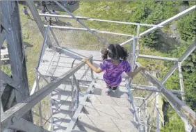  ?? Herb Terns / Times union ?? outdoor writer Gillian Scott’s daughter descends the steps of the Hunter Mountain fire tower, her first fire tower peak, in 2016, when she was 6.