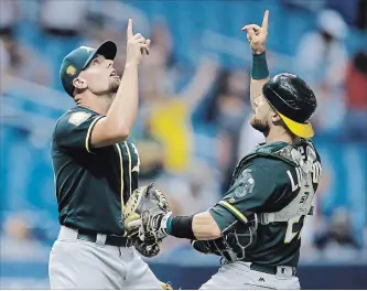  ?? ASSOCIATED PRESS FILE PHOTO ?? Oakland Athletics closer Blake Treinen, left, celebrates a win with catcher Jonathan Lucroy. The small-market A’s could be a tough out against the New York Yankees in the American League wild-card game.