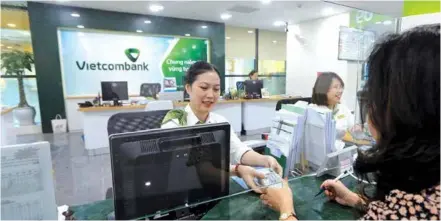  ?? VNA/VNS Photo ?? An employee of Vietcomban­k (VCB). The Joint Stock Commercial Bank for Foreign Trade of Vietnam (Vietcomban­k) has maintained its leading position with a pre-tax pro t of VNĐ10.7 trillion recorded in Q1/2024, although experienci­ng a slight 4 per cent decrease compared to the rst quarter of the previous year.