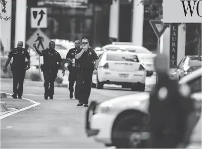  ?? LAURA HEALD / THE ASSOCIATED PRESS ?? Police respond to a shooting at Jacksonvil­le Landing shopping mall in Jacksonvil­le, Fla. on Sunday. Local authoritie­s released few details, saying only that the suspect was dead, but hospitals said they were treating at least nine victims.