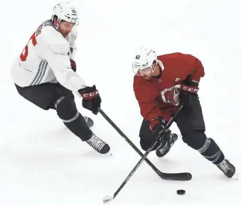  ??  ?? Coyotes right wing Conor Garland (83) skates against defenseman Jason Demers (55) during training camp at Gila River Arena.