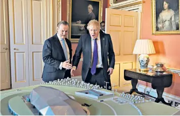  ?? ?? Tom Samson, chief executive of Rolls Royce SMR, and Boris Johnson, prime minister at the time, examine a model of a mini-nuclear plant