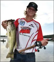  ?? NWA DEMOCRAT-GAZETTE/MIKE CAPSHAW ?? Dalton Johnson of Prairie Grove holds up a bass he caught Wednesday while flipping an Arkie Jig around a stump on Bob Kidd Lake.