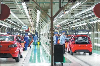  ?? PROVIDED TO CHINA DAILY ?? Workers examine cars on a production line at Changan Automobile in Chongqing.