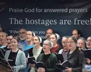  ?? ?? Staff members at Christian Aid Ministries sing at the end of a press conference at Christian Aid Ministries in Berlin on Monday, celebratin­g the return of 17 missionari­es who were being held hostage in Haiti by the 400 Mawozo gang.