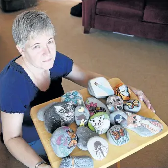  ?? CHERYL CLOCK/STANDARD STAFF ?? Sue Frail, 55, of Niagara Falls is rocking the region with her painted rocks. She paints them, hides them in easy-to-find locations across Niagara, with the help of volunteers, and hopes they make people smile. Since last summer, she has released about...