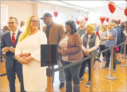  ?? Bizuayehu Tesfaye Las Vegas Review-journal @bizutesfay­e ?? Nebraskans Marylyn Barnett and Trevor Pennock head the line of people waiting to get their marriage license Friday at the Marriage License Bureau in Las Vegas. Clark County officials expected long lines on Valentine’s Day.