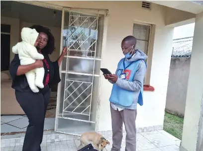  ?? ?? Mr Richard Chimbuya, an enumerator, goes through the 2022 national housing and population census questionna­ire with The Manica Post editor, Mrs Wendy Nyakurerwa-Matinde, at her home in Chikanga on Wednesday.