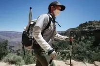  ?? Mario Tama, Getty Images ?? A park ranger wears a face mask while patrolling the Bright Angel trail at Grand Canyon National Park.