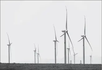  ?? KALIZHAN OSPANOV / XINHUA ?? Wind turbines are seen on Central Asia’s largest wind farm built by a Chinese firm near the city of Zhanatas in the Zhambyl region, Kazakhstan, on May 24.