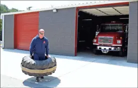  ??  ?? Lt. Michael Cook lifts a tire for a PT exercise. LaFayette Fire Department may service the city specifical­ly, but Chief Meeks says that city and county agencies all “work together” with their resources of equipment and manpower for the common good of the entire Walker County area of Northwest Georgia.