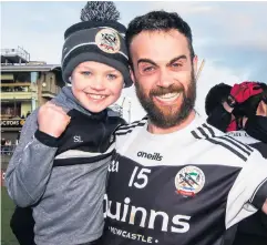  ??  ?? Winning feeling: Conor Laverty celebrates with his son, Setanta