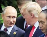  ?? HAU DINH — THE ASSOCIATED PRESS ?? Russian President Vladimir Putin, left, and U.S. President Donald Trump talk as they arrive for the family photo session during the Asia-Pacific Economic Cooperatio­n (APEC) Summit in Danang, Vietnam, Saturday.