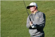  ?? GOMOCS. COM ?? UTC golfer and McMinn Central graduate John Houk watches the flight of a shot in a recent tournament. Houk has been a part of the Mocs’ recent resurgence as a program as the Mocs should be in the hunt for a Southern Conference title this week.