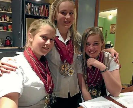  ?? PHOTO: JAMES PAUL/STUFF ?? Jemma Brisk, left, Cerys Poore, and Kate Powell of Aotea College brought home a haul of 36 medals from the World Scholar’s Cup in South Africa. Left, during the competitio­n.