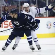  ?? JOHN WOODS/THE CANADIAN PRESS ?? Leaf Auston Matthews looks for a penalty call with his stick tied up by Shawn Matthias of the Jets Wednesday night.