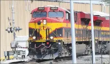  ?? Westside Eagle Observer/MIKE ECKELS ?? A southbound Kansas City Southern grain train passes through the Roller Avenue crossing on its way to parts unknown Aug. 20, 2019. According to KCS, 12-15 trains cross over this intersecti­on on a daily basis.
