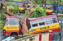  ?? PTI ?? A bus wrecked by a fallen tree in Kolkata yesterday. Amphan left a trail of destructio­n in the Indian city of 14 million people.