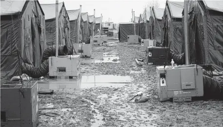  ?? PHOTO COURTESY OF LLOYD MOON ?? When it rained or snowed, the ground around the tents at Uzbekistan’s Karshi-Khanabad, or “K2,” turned to mud, rendering the DOD’s gravel useless.