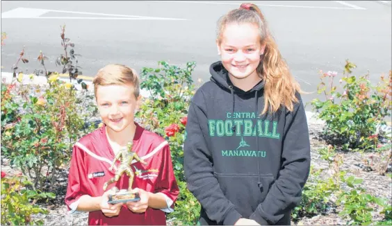  ??  ?? AUSTYN Beales holds his MVP cup for the U-10 group next to Aimee Powick, who has the potential to become a federation player.
