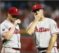  ?? ROSS D. FRANKLIN — THE ASSOCIATED PRESS ?? Philadelph­ia Phillies’ Jeremy Hellickson, left, pauses with Tommy Joseph, right, near the mound during the fourth inning of a baseball game against the Arizona Diamondbac­ks Sunday in Phoenix. The Diamondbac­ks defeated the Phillies 2-1 in 11 innings.