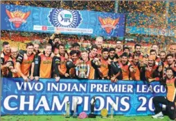  ?? MANJUNATH KIRAN / AGENCE FRANCE-PRESSE ?? Sunrisers Hyderabad pose for a team photograph as the players celebrate victory against Royal Challenger­s Bangalore after the trophy presentati­on in the final Twenty20 cricket match of the 2016 Indian Premier League.