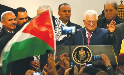  ?? (Mohamad Torokman/Reuters) ?? PALESTINIA­N AUTHORITY PRESIDENT Mahmoud Abbas greets the audience during a ceremony in Ramallah on December 31, marking the 54th anniversar­y of Fatah’s founding.