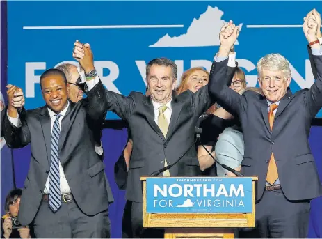  ?? /Reuters ?? Power trio: Virginia governor Ralph Northam, centre, celebrates with lieutenant-governor Justin Fairfax, left, and attorney-general Mark Herring at Northam’s election night rally in Fairfax, Virginia, on November 7, 2017.