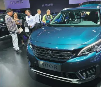  ?? CAO YINGYING / CHINA DAILY ?? Peugeot’s 5008 compact MPV is displayed to visitors at the Chengdu auto show last year.