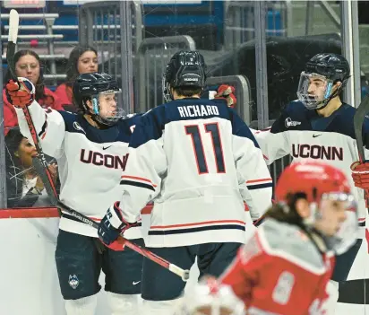  ?? UCONN ATHLETICS ?? Uconn’s Jake Richard rushes to congratula­te Hudson Schandor after Schandor’s second first-period goal against Sacred Heart during the Huskies’ opening game in the annual CT Ice tournament at the XL Center on Friday.