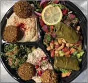  ?? COURTESY OF MAZRA ?? A Falafel Mezza Sampler with Mazra's signature sides and dips is a favorite with diners. The San Bruno restaurant soon will open a second location, in Redwood City.