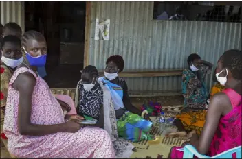  ?? DENG MACHOL — THE ASSOCIATED PRESS ?? Expectant mothers sit on the floor as they wait to attend a monthly checkup at the Mingkaman Reproducti­ve Health Clinic in the village of Mingkaman, Awerial County, in the Lakes State of South Sudan on Oct. 19.