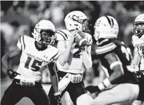  ?? Juan DeLeon / Contributo­r ?? A&M Consolidat­ed QB Gage Pahl (2) scans the secondary for an open receiver in the first half of the team’s matchup against Lamar Consolidat­ed on Saturday night. He finished with 195 yards and five touchdowns on 12-of-20 passing.