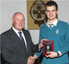  ??  ?? Former Detective Garda Ben O’Sullivan presents Charlevill­e C.B.S. Secondary School student Paddy O’Loughlin with the A.I.B. Sportspers­on of the Year Award at the school’s annual awards day.