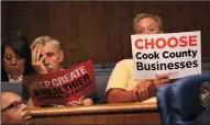  ?? NANCY STONE/CHICAGO TRIBUNE ?? A supporter to keep the soda tax, left, and one to repeal it are seated next to each other at the Cook County Board meeting finance committee on Tuesday in Chicago. The tax was repealed Wednesday.