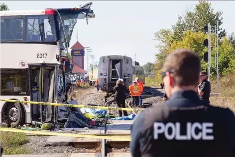  ?? WAYNE CUDDINGTON/FILES ?? Sept. 18, 2013 The front of the bus is barely distinguis­hable as firefighte­rs and police search at the scene of a crash between an OC Transpo double-decker bus and a VIA train near the Fallowfiel­d station in Barrhaven. The bus driver and five passengers died.