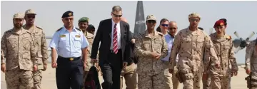  ??  ?? US Ambassador to Yemen Matthew H Tueller (front, third left) arrives at Mukalla airport, southweste­rn Yemen. — AFP photo