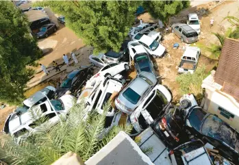  ?? AMER HILABI/GETTY-AFP ?? A massive pile-up of cars blocks an alley after torrential rains Friday in Jeddah, Saudi Arabia. At least two were killed Thursday as heavy rains hit western Saudi Arabia, delaying flights and forcing schools to close, officials said.