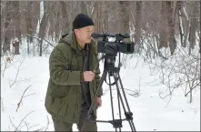  ?? PROVIDED TO CHINA DAILY ?? Yang Haishan, a retired forest ranger, records the status of wild animals in the reserve.