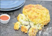  ?? MELISSA D’ARABIAN VIA AP ?? A cheesy pull-apart whole roasted cauliflowe­r. This dish is from a recipe by Melissa d’arabian.