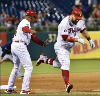  ?? DERIK HAMILTON — THE ASSOCIATED PRESS ?? The Phillies’ Cameron Rupp, right, is congratula­ted by third base coach Juan Samuel after home run off Milwaukee relief pitcher Jacob Barnes during the eighth inning Saturday. hitting a two-run