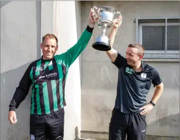  ??  ?? Arklow United joint captains Mark Nolan and Paul Lalor lift the Thomas Scott Cup.