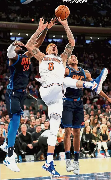  ?? — AFP ?? Towering performanc­e: New York Knicks’ Michael Beasley taking a shot as Oklahoma City Thunder’s Patrick Patterson (left) and Josh Huestis try to stop him in the NBA game at Madison Square Garden in New York on Saturday. The Knicks won 111-96.