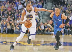  ?? EZRA SHAW / GETTY IMAGES / AFP ?? Kevin Durant of the Golden State Warriors dribbles past Russell Westbrook of the Oklahoma City Thunder at Oracle Arena in Oakland, California, on Wednesday. Durant scored 40 points to lead the Warriors to a 121-100 victory.