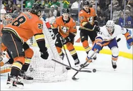  ?? Alex Gallardo Associated Press ?? THE ISLANDERS’ Zach Parise, right, battles for the puck against Ducks defenseman Nathan Beaulieu (28) during the first period of New York’s victory