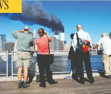  ?? HENNY RAY ABRAMS / AFP VIA GETTY IMAGES FILES ?? On the morning of Sept. 11, 2001, New Yorkers woke to crisp, cloudless blue skies — little portent of the dark,
history-changing day that was to come and that would remain etched on the memories of those affected.