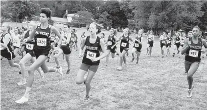  ?? PHIL GROUT/BALTIMORE SUN MEDIA GROUP ?? Patuxent’s Haley Jackson (No. 1320) sprints out from the pack at the start of the invitation­al. Jackson won at a course she had never run in her career — and broke the Barnhart meet record — with a time of 18:03.91. Hereford’s Kelly Wesolowski took...