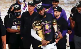  ?? Photograph: Mike Ehrmann/Getty Images ?? LeBron James with the NBA trophy and NBA finals MVP award after the Lakers clinched their 17th title.