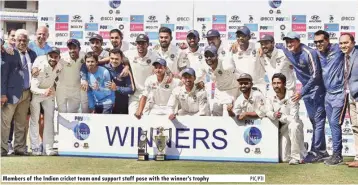  ?? PIC/PTI ?? Members of the Indian cricket team and support staff pose with the winner’s trophy