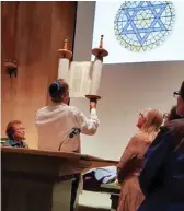  ?? ?? Stephen Lewis Fuchs holds the Torah rescued by the Congresses.
Link to NBC Nightly News video of the Torah recovery effort